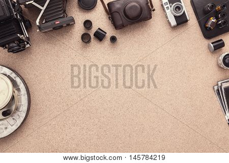 Photographer Desk. Photographer workplace. Photographer scrapbook. Tradional Photography. Black and White Photography. Many cameras. Copy space. View from above. Negatives. Roll of films.