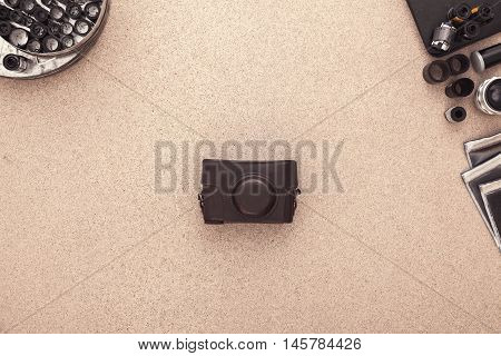 Many vintage cameras on wooden table. Photographer Desk. Photographer workplace. Tradional Photography. Black and White Photography. Negatives. Roll of films.