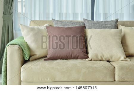 Brown Pillows On Light Brown Leather Sofa
