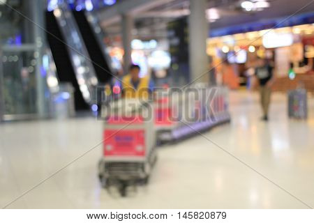 Abstract Background, Blurred Image Of A Man Working With Trolleys Luggage In Corridor Of Terminal Pa