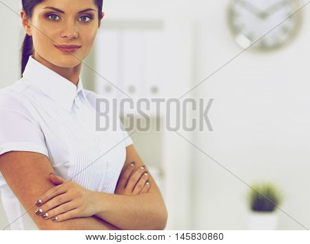 Attractive businesswoman with her arms crossed stnding