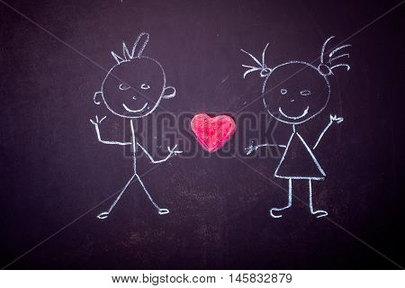drawing with chalk on black Board girl with boy