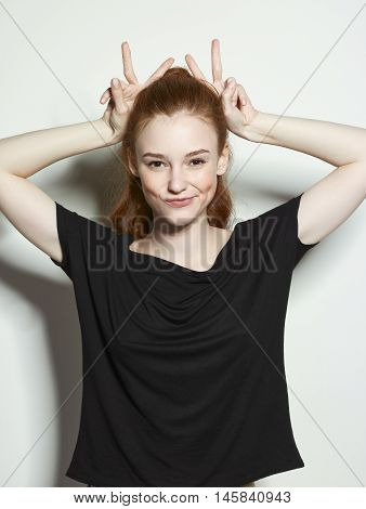 Emotional beauty portraits red-haired girl. On a neutral background.