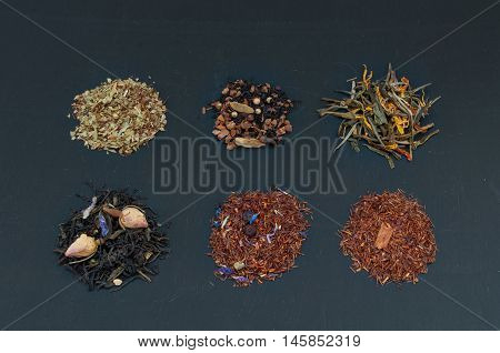 Assortment Of Dried Teas On Dark Background