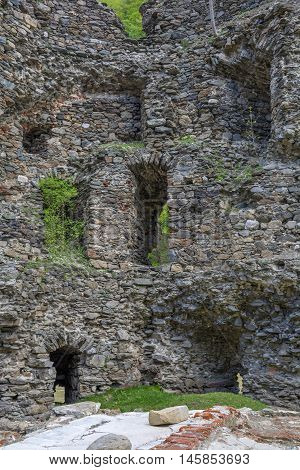Inside the walls. Medieval broken tower. The custom-house on Olt river in Carpathian mountains.