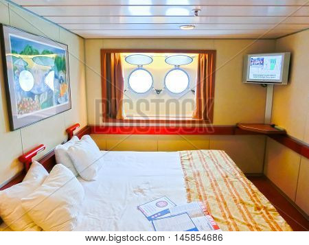 San Juan, Puerto Rico - May 08, 2016: The inside cabin with two portholes at Carnival Cruise Ship Fascination. She is one of 8 sister ships and received a million dollar refurbishment in 2006
