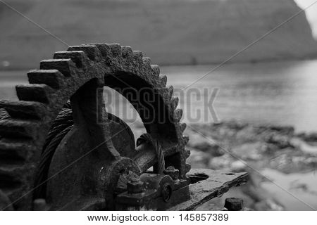 Rusted iron wheal at the coastline in the Faroe Islands