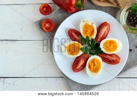 Boiled egg and fresh tomato black bread - light diet breakfast. The top view