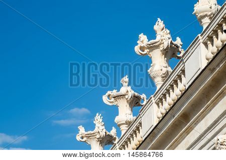 Beautiful white stone classic balustrade with sculptures and clear blue sky background