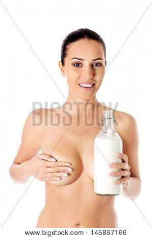 Nude woman is holding a ewer of milk. Spa concept.