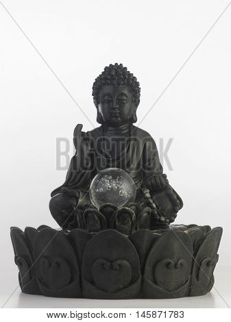 black Buddha statue in a sitting position on the white background