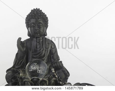 black Buddha statue in a sitting position on the white background