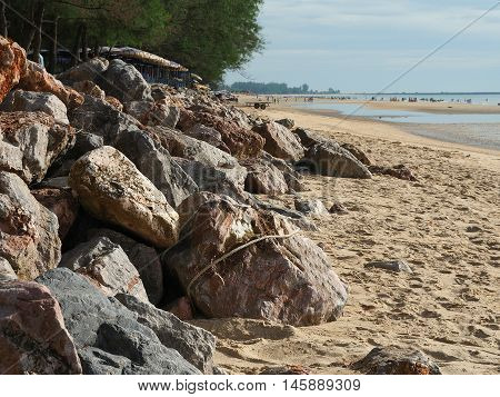 Coast rock dam on the beach to protect from coastal erosion