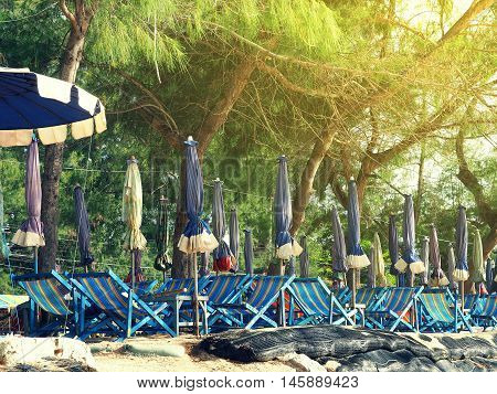 Colorful beach chairs and umbrellas with sunny light for tourism relax in vocation at Cha-Am beach Thailand