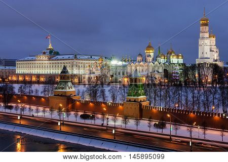 Winter night view of the Moskva River and Moscow Kremlin, where the Grand Kremlin Palace, Assumption Belfry with Gostunskii Nicholas Cathedral, the Archangel Cathedral and the Annunciation Cathedral.