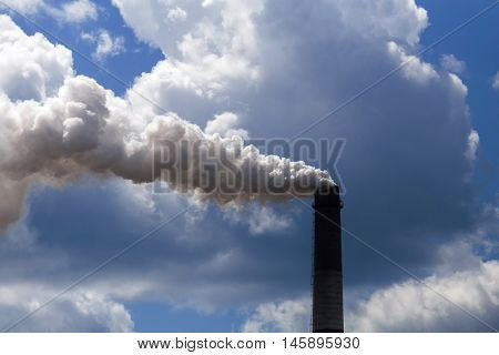 Pipe heavy industry factory emits into the air precipitation, smog and gas, polluting the planet.