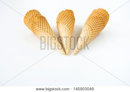 Composition of three ice cream cone stacks isolated on white background.