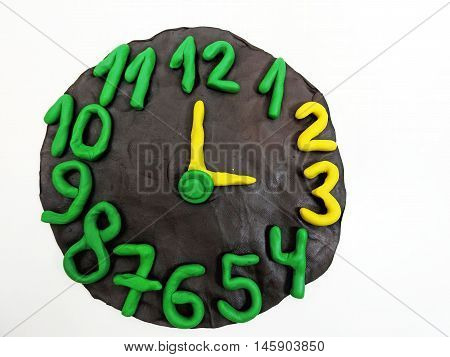 Round clock from plasticine going to winter time