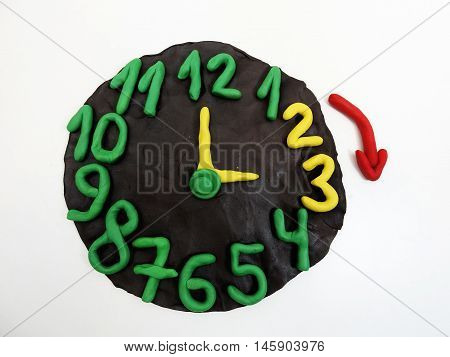 Round clock from plasticine going to winter time