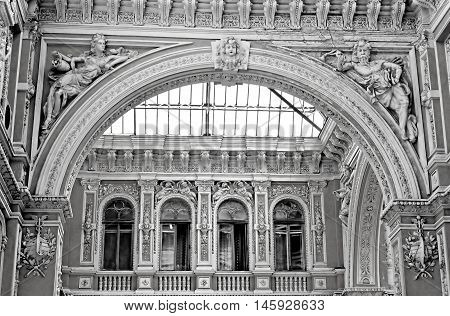 Sculptures of modernist style on the balcony of Odessa passage - old covered mall and architectural monument, Odesa, Ukraine. Black and white