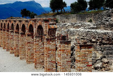 Sirmione Italy - June 1 2006: Ruins of the Roman villa which belonged to the poet Catullus at the Grottoes of Catallus overlooking Lake Garda