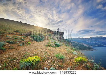 Traveler in the mountains. Photographer in the mountains near the sea