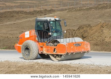 Taman, Russia - March 8, 2016: Rink Evens Gravel, Preparing The Way For The Laying Of Asphalt