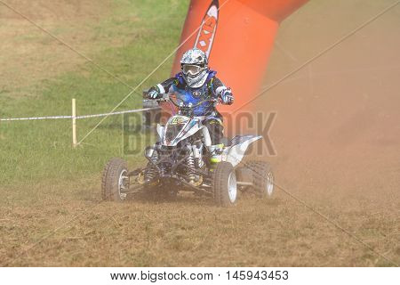Unidentified Racer Rides A Quad Motorbike.