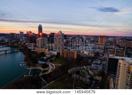 Aerial Austin Texas Skyline at Sunset golden hour with pink horizon over Downtown urban skyscrapers and Frost bank tower with the Austonian highest residential tower in Texas