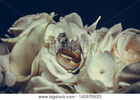 Wedding Rings Closeup On White Rose