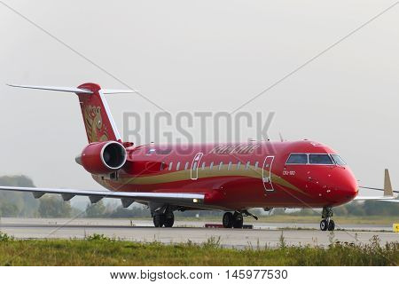 MOSCOW, RUSSIA - SEPTEMBER 26, 2014: Rusline Airlines Bombardier Canadair Regional Jet CRJ-200 aircrafts registration number VQ-BNB taxiing after landing in Domodedovo International airport