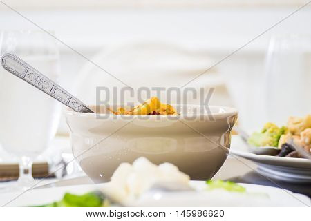 Curry put the cup on the table in lanch meal