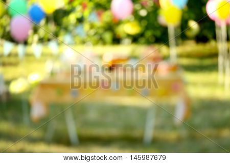 Birthday table in yard on blurred background