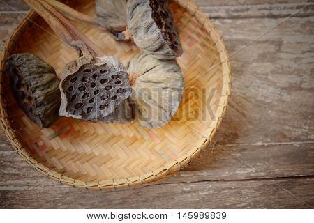 Lotus seed on wooden background ,soft focus and retro style.Copy space.