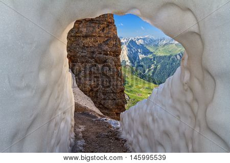 ice tunnel in Sass Pordoi pass on background Fassa Valley