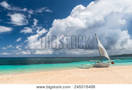 boat at white Puka beach of Boracay island Philippines