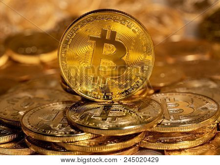 Morgantown, Wv - 13 June 2018: Macro Image Of Bitcoin Cybercurrency Coin Standing On Top Of A Stack 