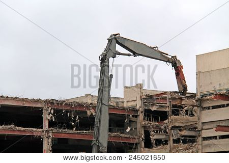 The Dismantling Of A Building With A Pulveriser Excavator.