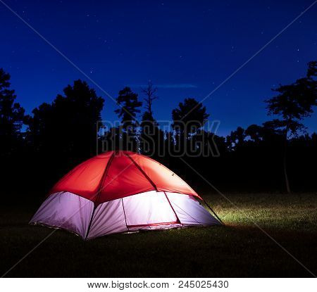 Stars Above A Lighted Nylon Tent Pitched In North Carolina