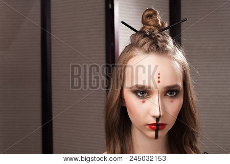 Beautiful Young Girl Model With Professional Unusual Mystic Makeup And A Coiffure With Topknot And B
