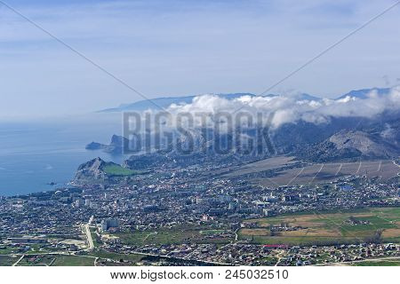 The Tops Of The Mountains Are Covered With Clouds. View From The Top Of Mount Ai-george (the Western
