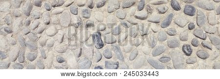 Background And Texture Of Granite Stone Wall Surface. Close Up Of A Natural Stone Carpet. Decorative