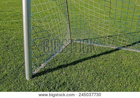 Bottom Corner Of A Football Goal On Green Grass