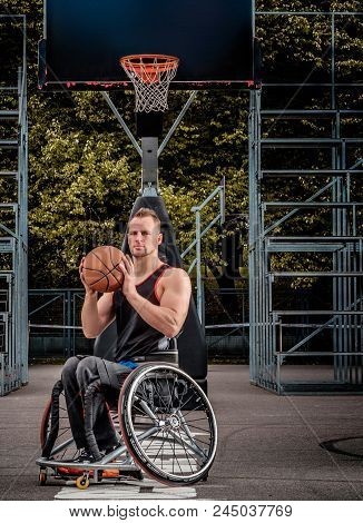 Portrait Of A Disabled Basketball Player In A Wheelchair On Open Gaming Ground.