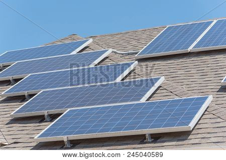 Solar Panel Installation On Asphalt Shingles Rooftop