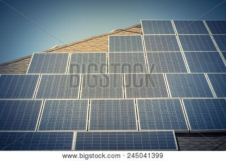 Solar Panel Installation On Asphalt Shingles Rooftop