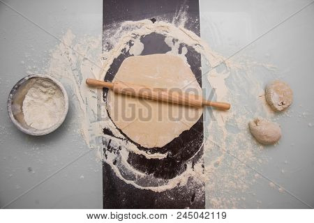 Pizza Dough, Rolling Pin And Ingredients On The Table