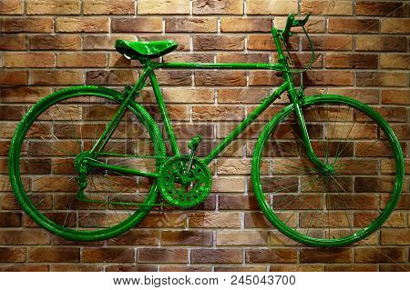 Green Bicycle On A Brick Wall. Unusual Beautiful Pink Tones.