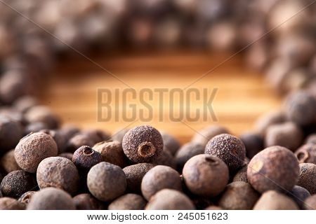 Close-up Circle Made Of Pimento Or Allspice On Rustic Wooden Background, Top View, Shallow Depth Of 