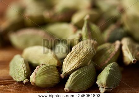 Close-up Of Green Cardamon Seeds On Rustic Wooden Background, Top View, Selective Focus, Shallow Dep